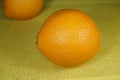 Two large bright Spanish oranges on the table