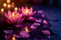 two large candles are beside a lotus flower on a dark background Royalty Free Stock Photo