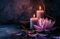 two large candles are beside a lotus flower on a dark background Royalty Free Stock Photo