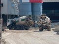 Two large cement truck trucks brought cement to the industrial area of the plant i