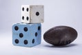 Two large dice and a rugby close-up on white background Royalty Free Stock Photo