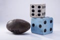 Two large dice and a rugby close-up on white background Royalty Free Stock Photo