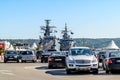 Two large gray modern warships at the pier in the seaport of Varna. View from the parking lot on a sunny summer day. Naval