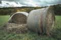 two large hay bails in the middle of a field Royalty Free Stock Photo