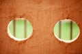 Two large holes in a wall, one on the left and one on the right Royalty Free Stock Photo