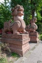 Two large lion stone statues in a buddhist temple Royalty Free Stock Photo