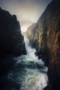 two large ocean cliffs forming a canal. crashing waves. Preikestolen