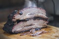 Two large pieces of smoked brisket meat on a wooden board Royalty Free Stock Photo