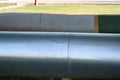 Two large pipes in isolation from tin on the oil refinery, petrochemical, chemical plant background