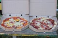 Two large round pizzas in gray paper packaging boxes Royalty Free Stock Photo