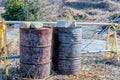 Two large rusted oil drums