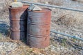 Two large rusted oil drums