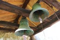 Two large rusty church bells in the bell tower of an old cave church