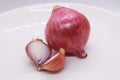two large shallots and one onion, cut on a plate Royalty Free Stock Photo