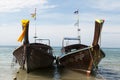 Two large traditional Thai boats with colorful ribbons and flags. Thailand Krabi