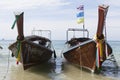 Two large traditional Thai boats with colorful ribbons and flags. Thailand Krabi