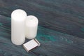 Two large white candles. Between them is a box of matches. Love and Togetherness Objects. On painted boards Royalty Free Stock Photo