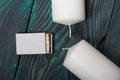 Two large white candles. Between them is a box of matches. Love and Togetherness Objects. On painted boards Royalty Free Stock Photo