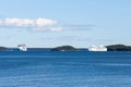 Two large white cruise ships anchored in Frenchman Bay during a sunny end of summer day