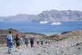 Two large white passenger ships between the islands of Santorini and Nea Kameni Royalty Free Stock Photo