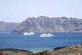 Two large white passenger ships between the islands of Santorini and Nea Kameni Royalty Free Stock Photo