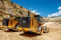 Two large yellow industrial bulldozers.