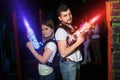 Two laser tag players standing back to back in bright beams Royalty Free Stock Photo