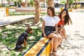 Two latin girls smiling happy sitting on bench with dog at the city Royalty Free Stock Photo