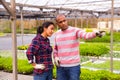 Two latino garden workers discussing working process