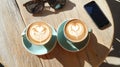 Couple\'s Morning Coffee Date Latte Art Heart, Sunglasses Smartphone on Rustic Table Royalty Free Stock Photo
