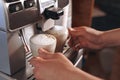 Two lattes with foam are in the coffee machine Royalty Free Stock Photo