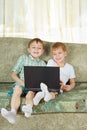 Two laughing boys with notebook