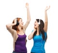 Two laughing girls with headphones dancing