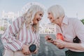 Two laughing older women are staying on square Royalty Free Stock Photo