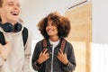 Two laughing teenagers in college. Smiling girl looking at her classmate in corridor Royalty Free Stock Photo