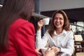 Two laughing women drinking coffee Royalty Free Stock Photo