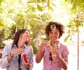Two laughing young girls blowing bubbles Royalty Free Stock Photo