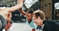 Laughing women planking and high fiving together while working o Royalty Free Stock Photo