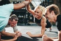 Female friends high fiving while planking at the gym Royalty Free Stock Photo