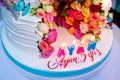 Two-layer cake . Wedding cake decorated with colorfull roses. Celebration party concept. flowers in the middle of the place where Royalty Free Stock Photo