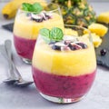 Two layer smoothie with black currant, quick oats, yogurt and pineapple, banana, square