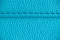 Two layers of blue cyan leather textile sewed stitched tightly together under high magnification close detail photography