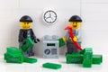 Two Lego minifigure robbers stealing money from a safe Royalty Free Stock Photo