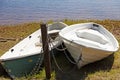 Two leisure boats locked with chains on land Royalty Free Stock Photo