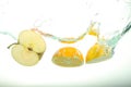Two, lemon and apple slices splash of water on white background Royalty Free Stock Photo