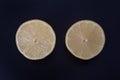 Two lemon halves against a black background Royalty Free Stock Photo