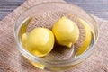 Two lemons in a bowl of water Royalty Free Stock Photo
