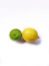 Two lemons ,one green ,one yellow with solid background. Royalty Free Stock Photo