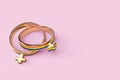 Two lesbian female wedding rings isolated on pastel pink background. Copy space included. LGBTQ+ people right to live together
