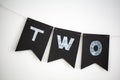 Two letters birthday decoration on black flags on a white background